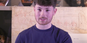 Male student in Classics Museum setting
